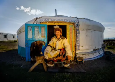 N. Khyzyrbek who is well known as Khijin, sitting in front of his ger with his eagle.
