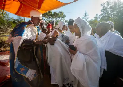 Priest, Megose, of the Saint George Church, Lalibela, is blessing the pilgrims during “Genna (Ethiopian Christmas)”.