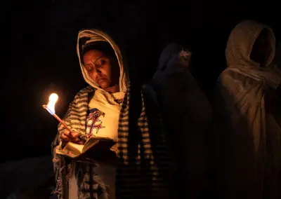 One lady pilgrims is praying during “Genna (Ethiopian Christmas)” festival at the Church of Saint George in Lalibela, Ethiopia.